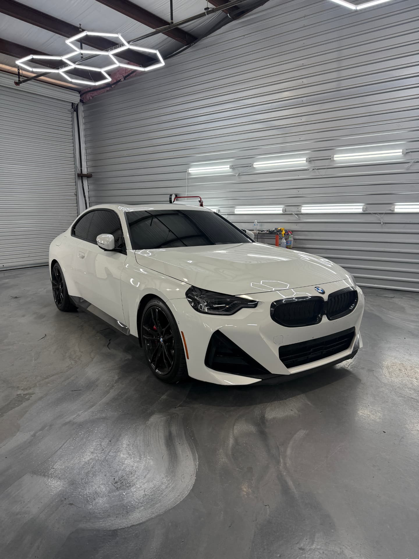 Careful paint protection film installation in a professional workspace